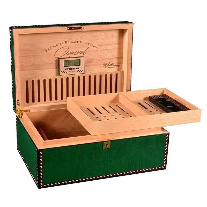 Open green wooden cigar humidor with a digital hygrometer, removable tray, and slotted compartments for cigar organization.